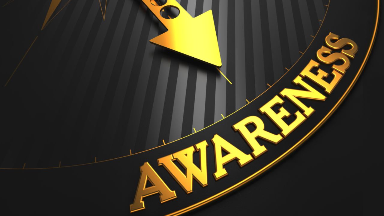 Close-up of a clock face with the word “Awareness” highlighted in gold, symbolizing recognition, timing, and the moment clarity begins to shape direction.