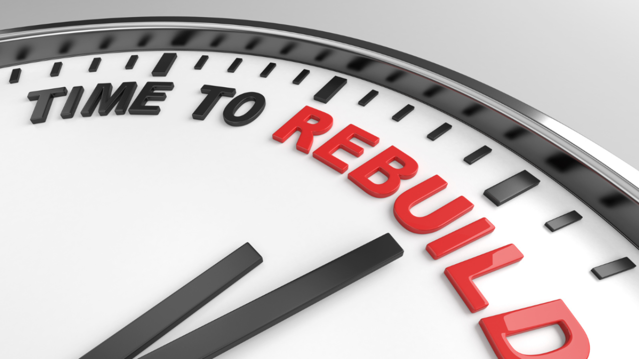 Close-up of a clock face with the words “Time to Rebuild” highlighted in red, symbolizing urgency, renewal, and the intentional decision to rebuild after hardship.
