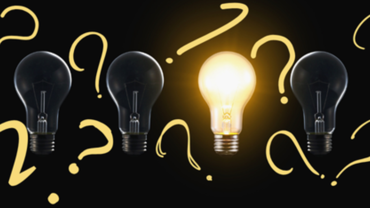 Glowing light bulb surrounded by question marks and unlit bulbs, symbolizing insight, curiosity, and clarity emerging through questioning.