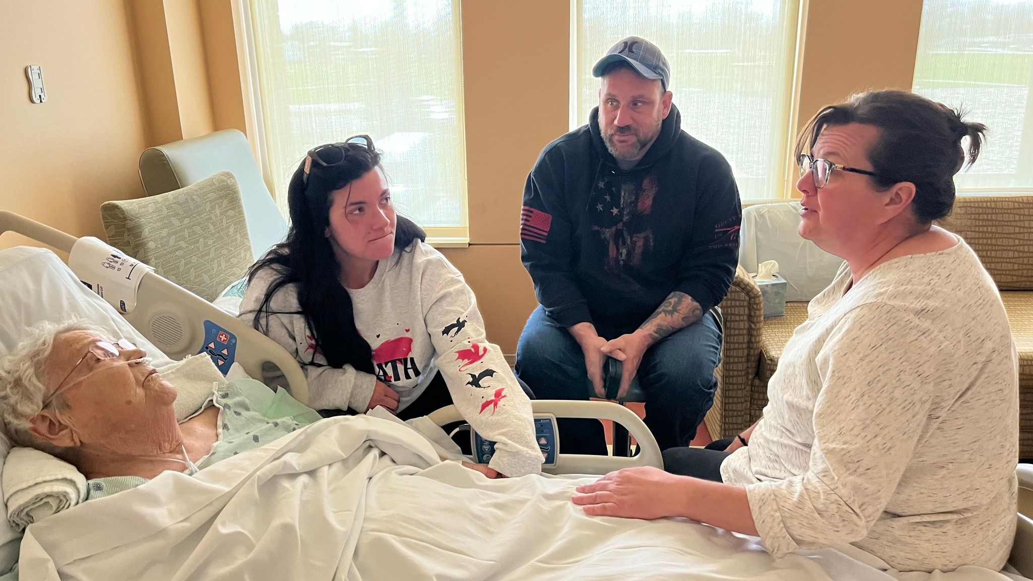 woman caring for her grandmother at her bedside