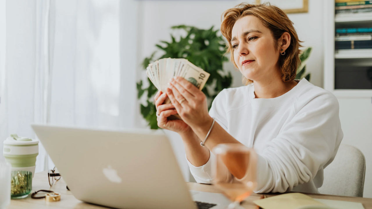 End-of-life practitioner holding cash she earned as income from her services
