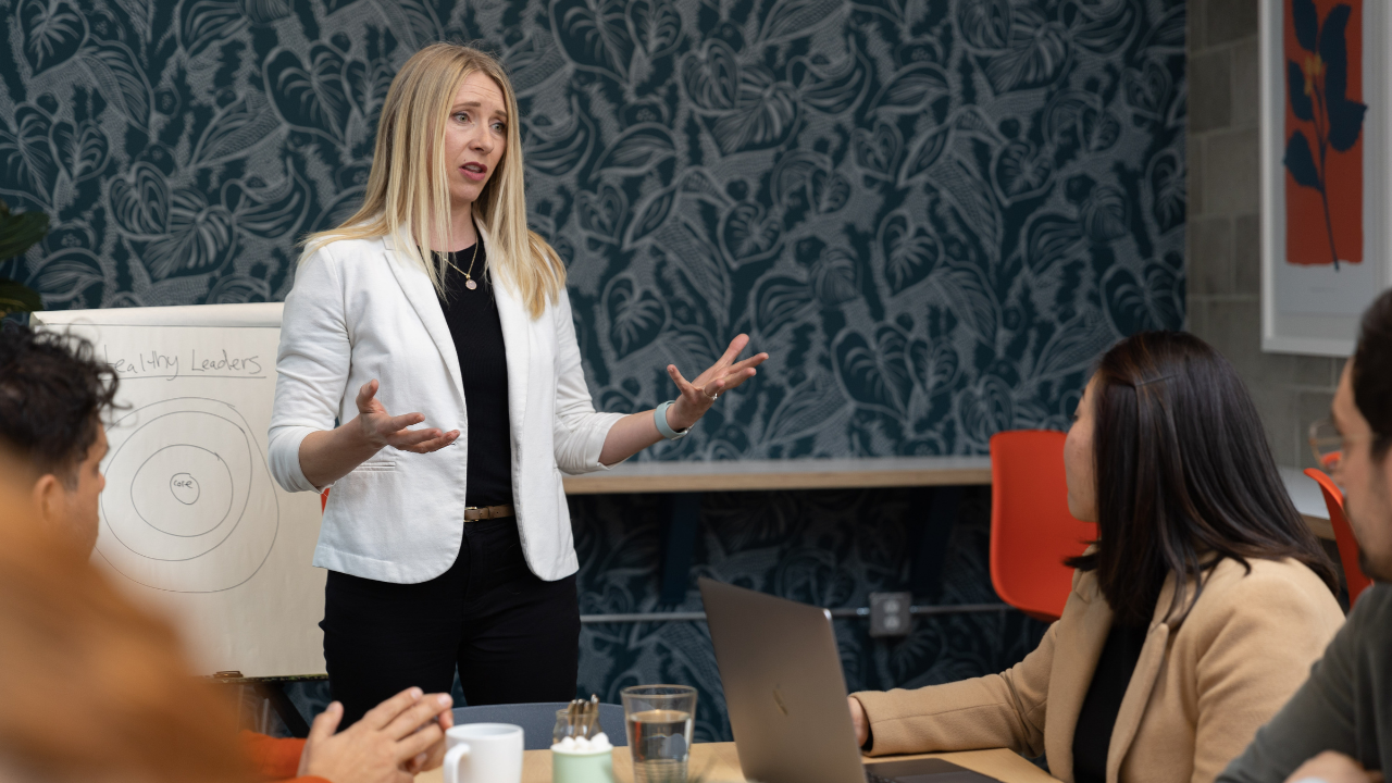 Female presenting in front of a room