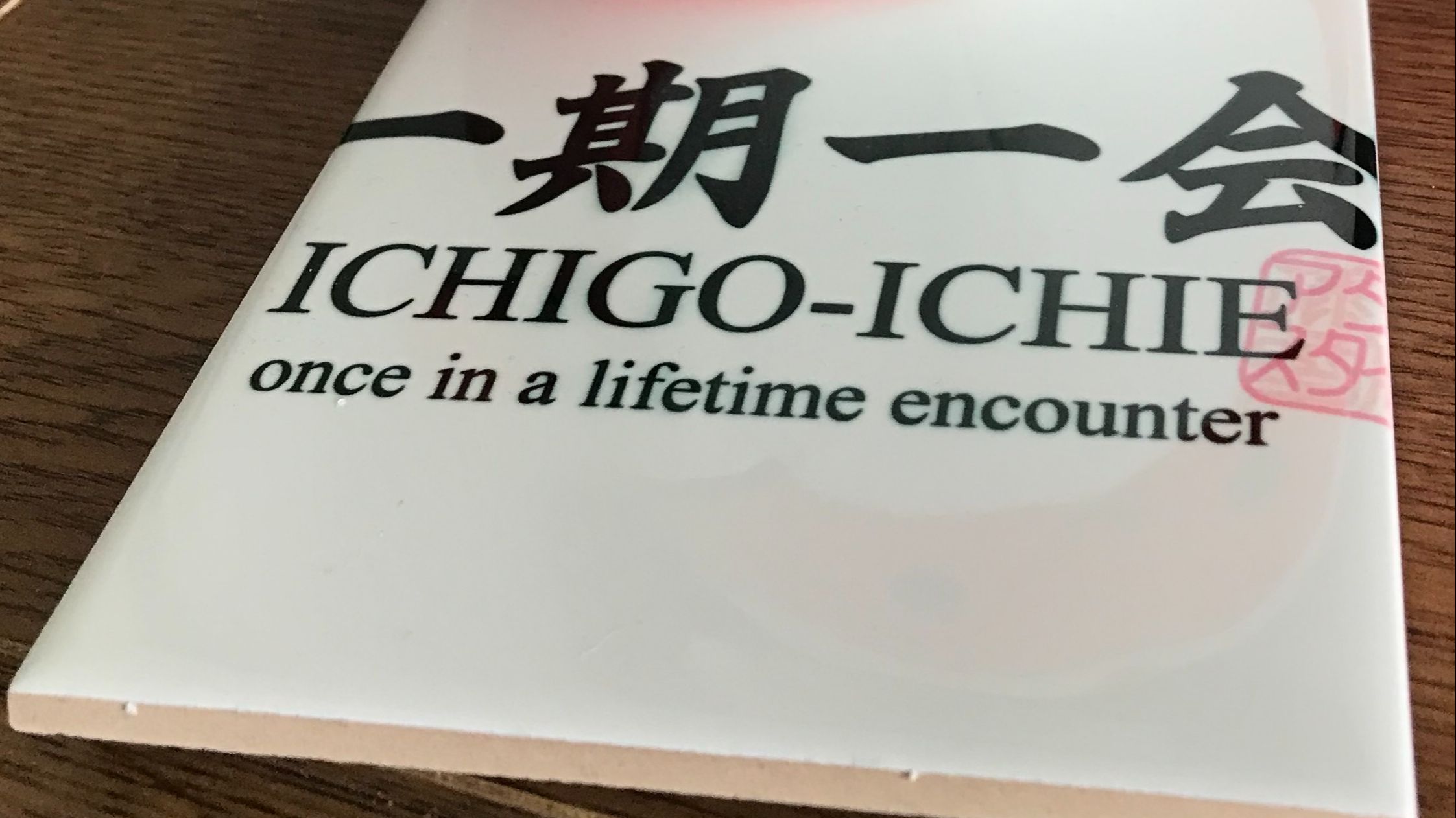 tile with inscription ichigo-ichie Japanese for once in a lifetime