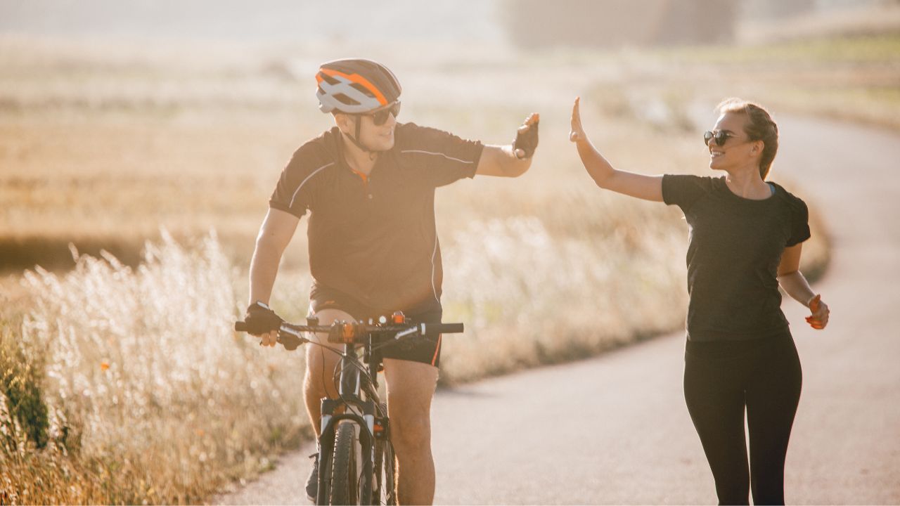 cyclist and jogger high five