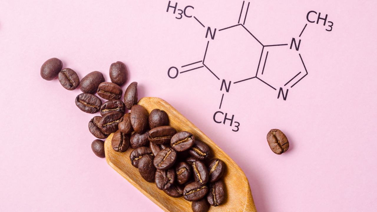 Coffee beans in a scoop with the chemical composition of caffeine on a pink background.