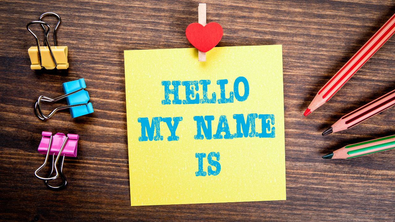 words hello my name is on post it note paperclips and pencils on desk