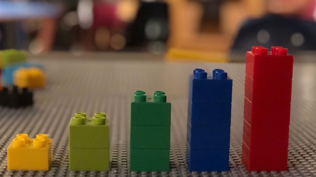 colored lego blocks getting taller in stacks left to right