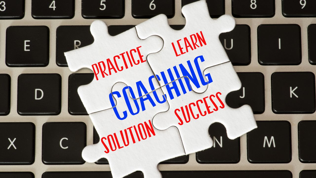 word coaching on 4 puzzle pieces on top of keyboard