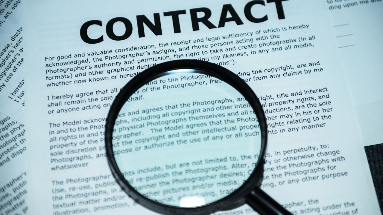 a contract with a magnifying glass over it