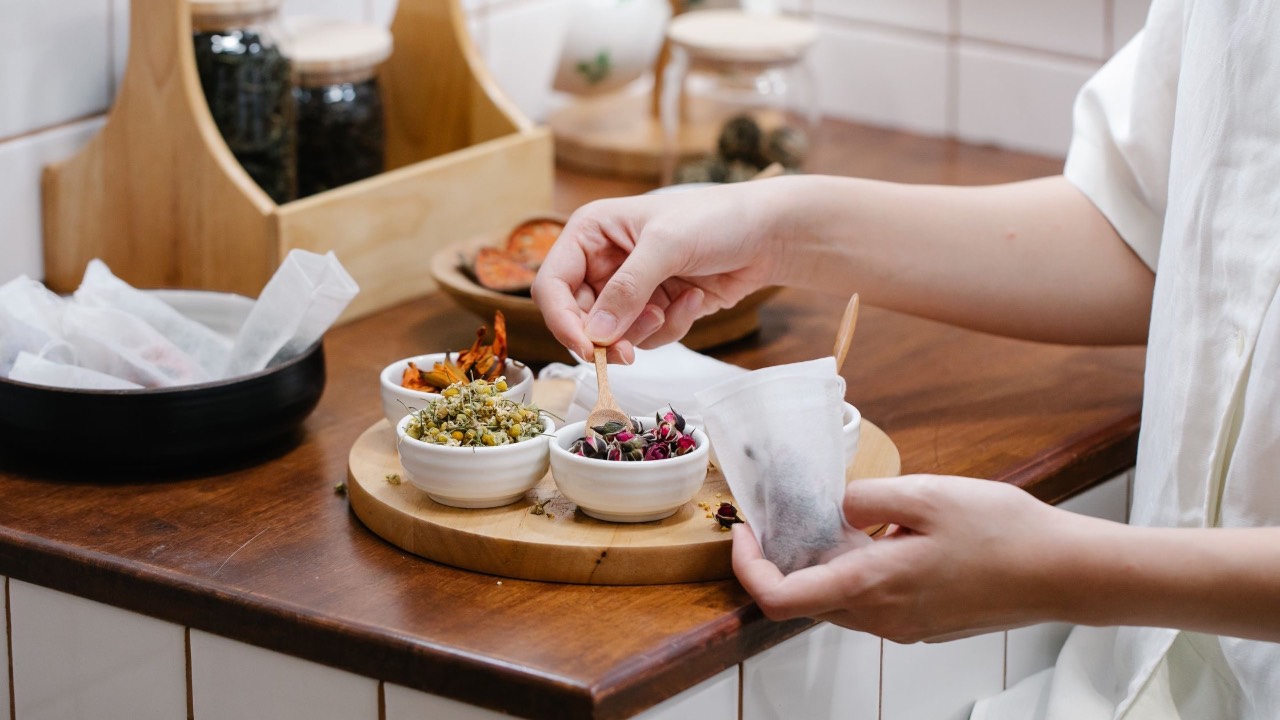 woman preparing herbs for infusion