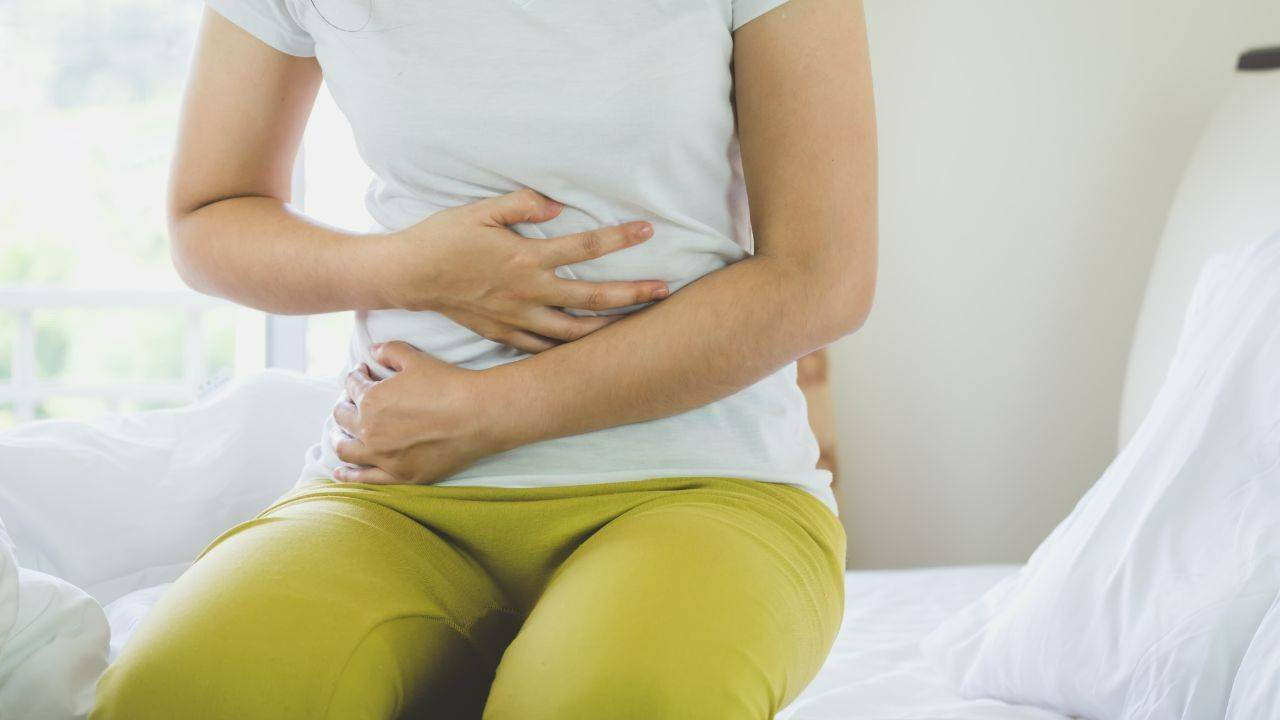 Woman enjoying a healthy meal to support digestion and reduce bloating