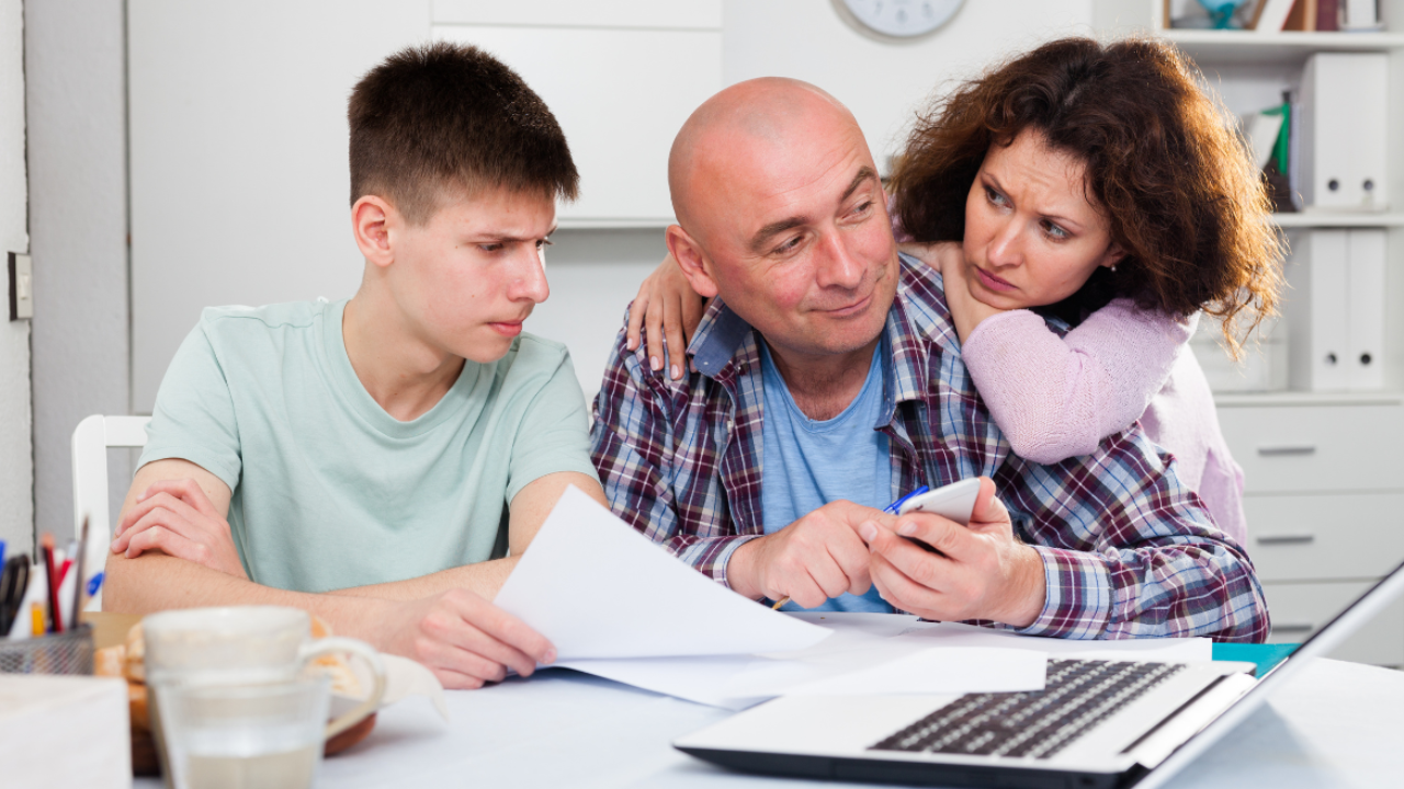 Family reviewing their finances together at home, planning for the future