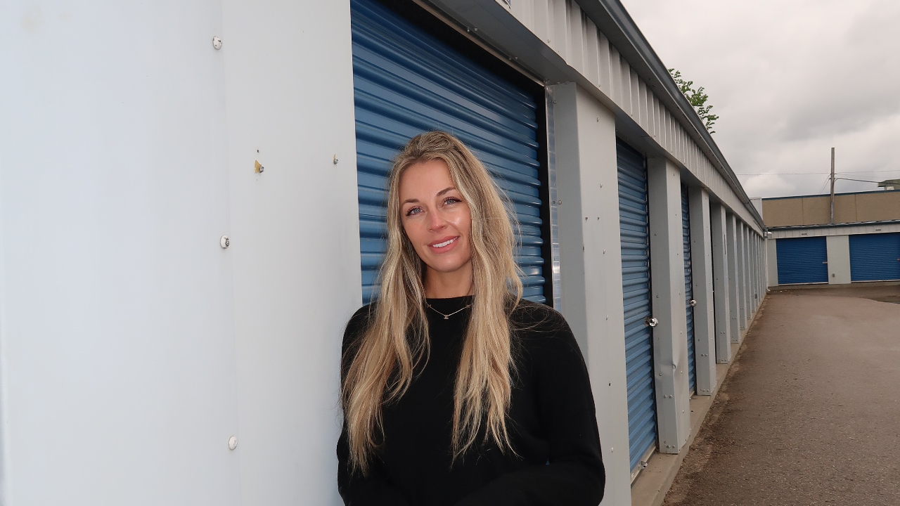 Brittany Arnason in front of self-storage units.