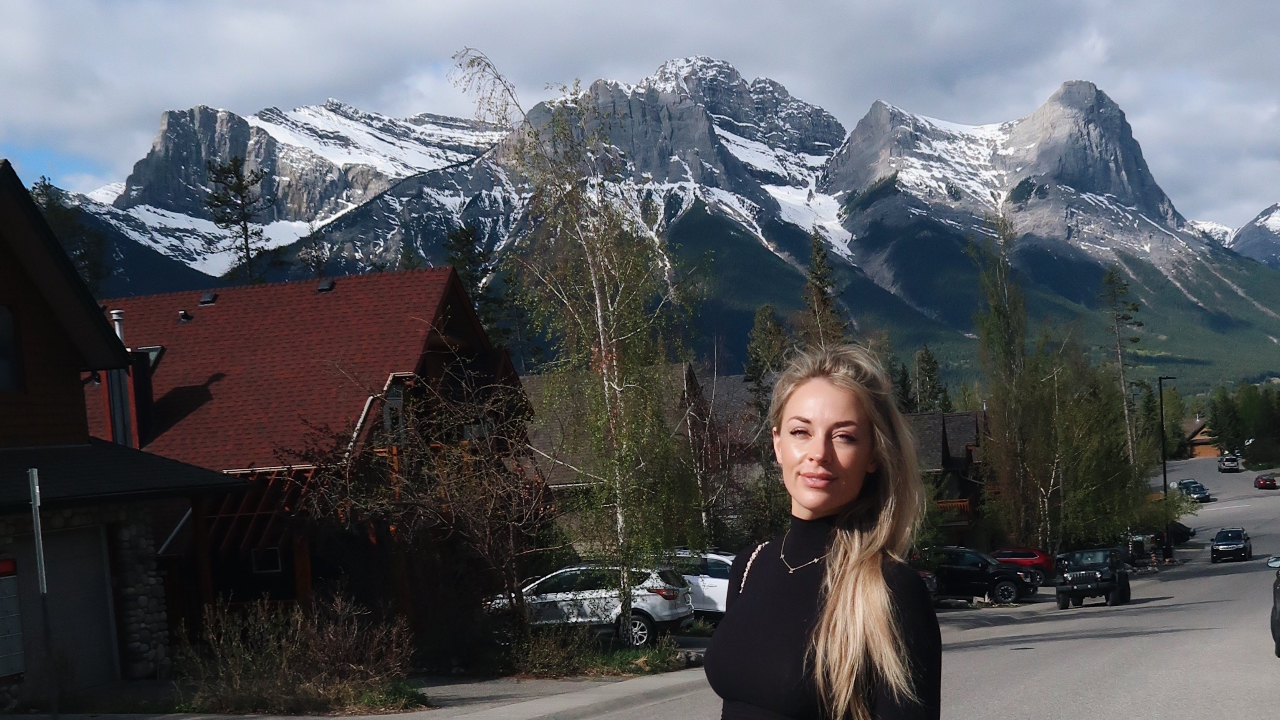 Brittany Arnason in front of Canadian Mountains in  Canmore