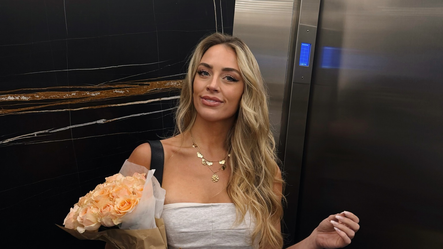 Brittany Arnason holding flowers and groceries.