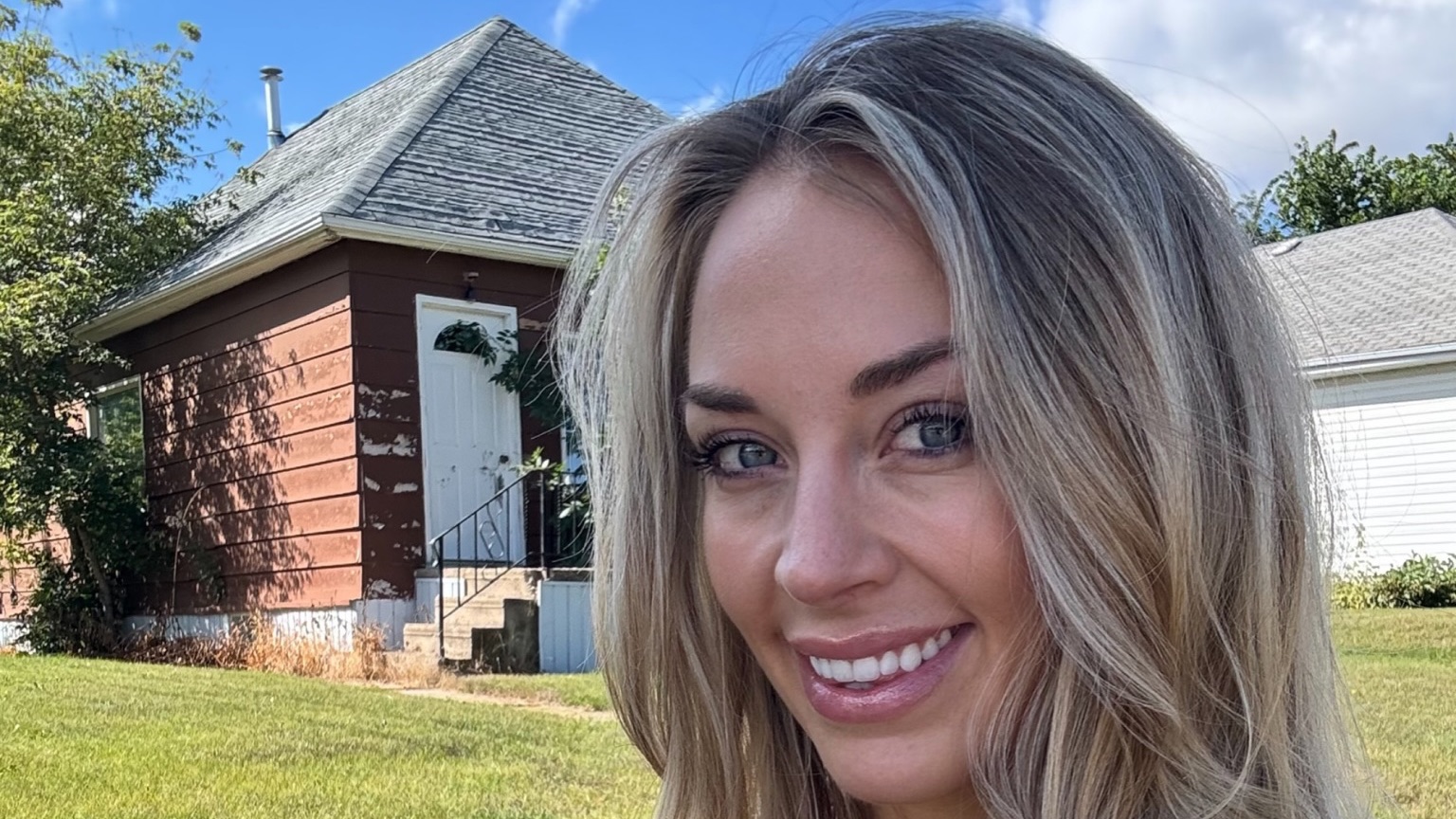 Brittany Arnason in front of the first house she bought.