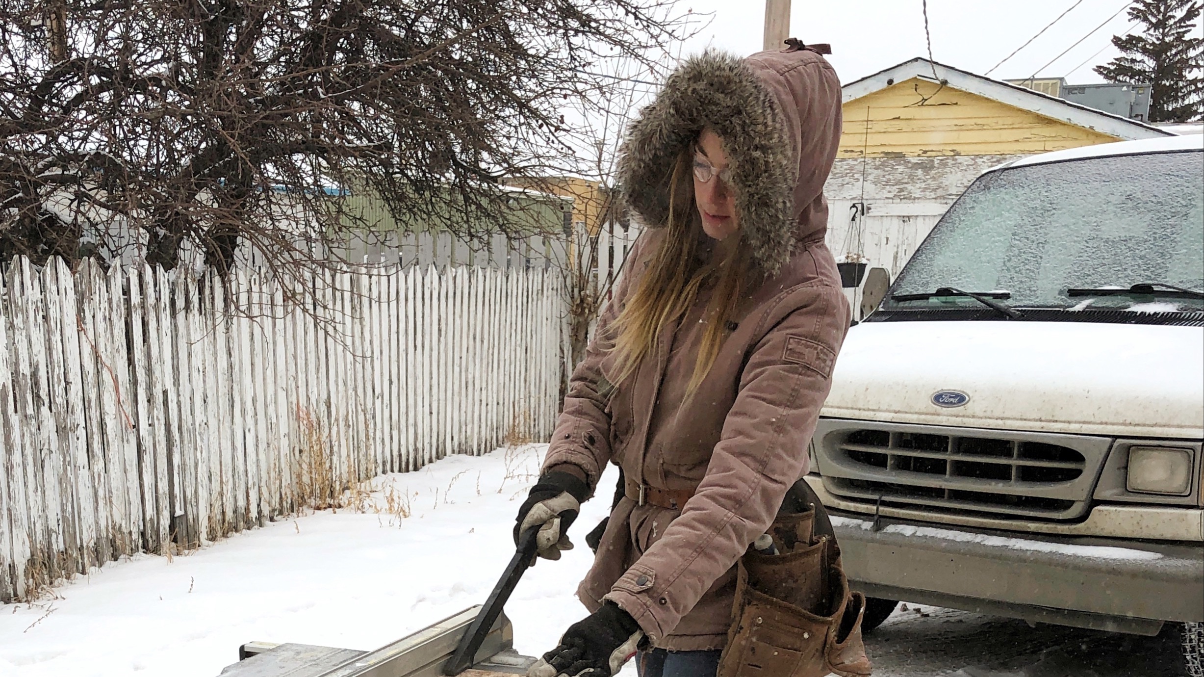 Brittany Arnason working with tools in front of her van.