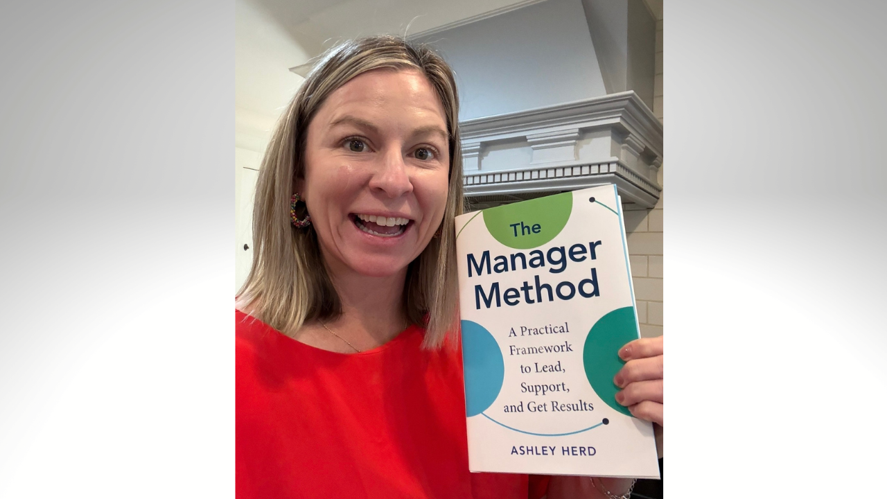 Standing happily in my kitchen holding a copy of The Manager Method that just arrived.