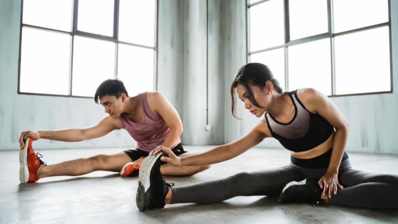 Attractive couple working out together releasing pheromones