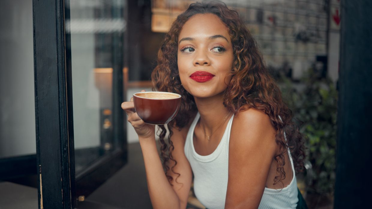 woman sitting down drinking coffee