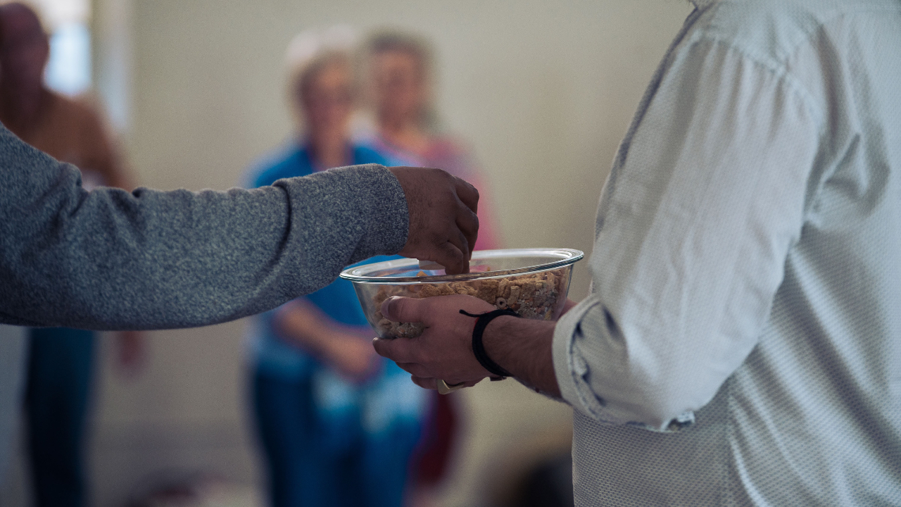 picture of someone holding a bowl giving an offering to someone else