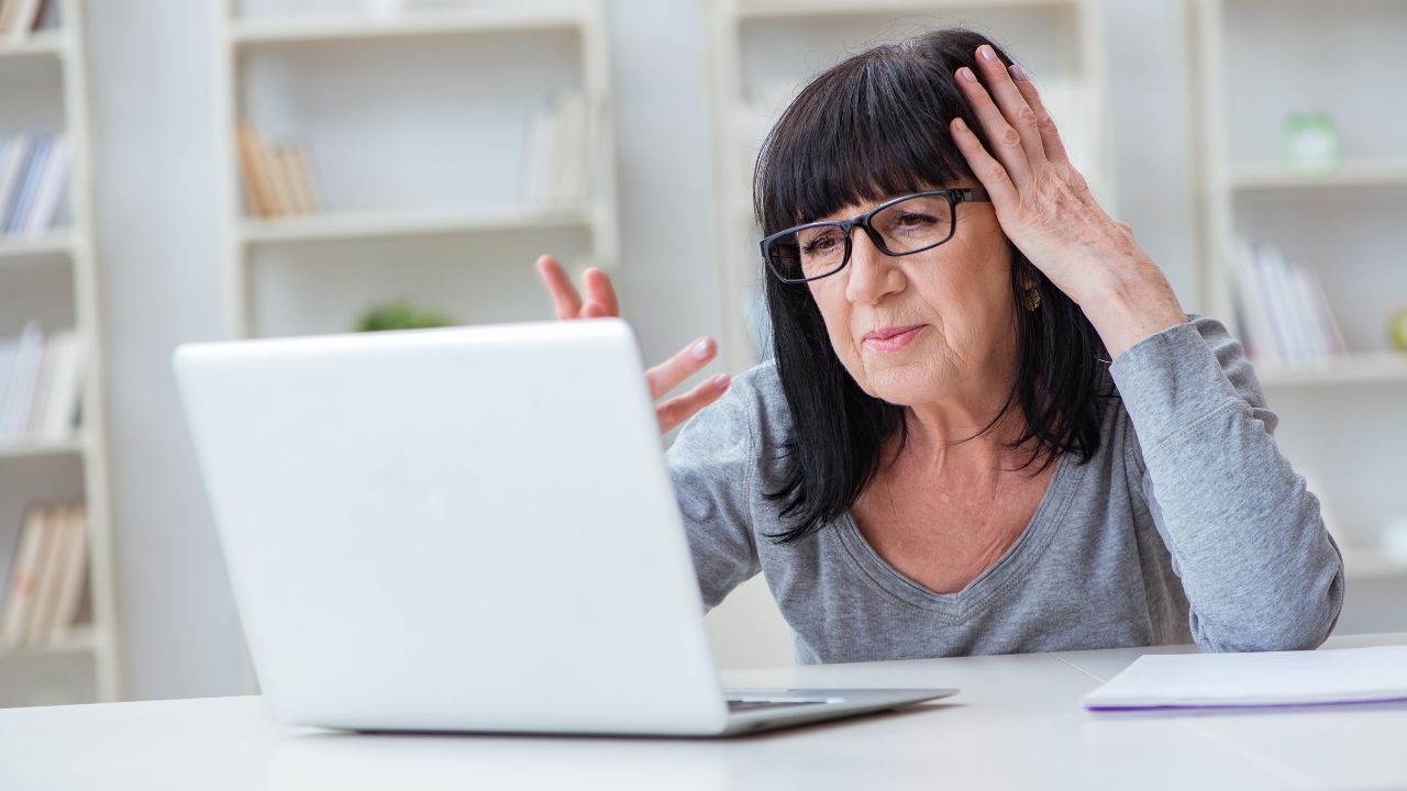 Woman writing her family history on computer