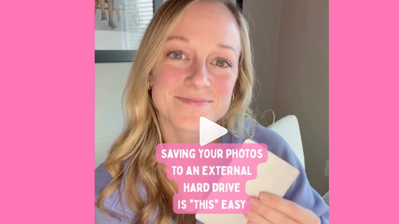 mom holding external hard drive with backed-up iPhotos