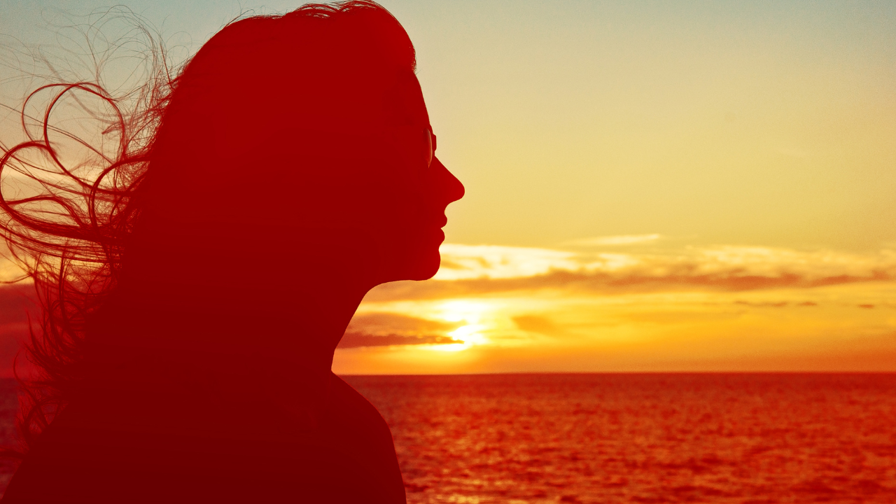 A health professional attentively listening to a female client while taking notes 