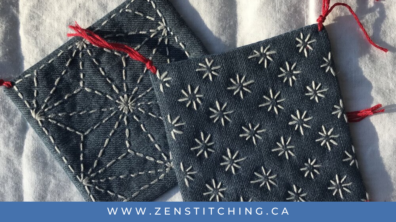 Two small coasters made from dark blue denim and decorated with sashiko stitching lay on a white fabric background. the bottom reads 