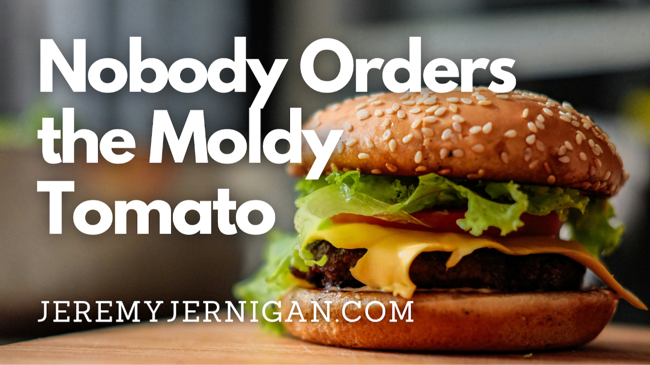 A close-up of a fresh, stacked burger with melted cheese and lettuce, illustrating the metaphor of faith deconstruction explored in the post