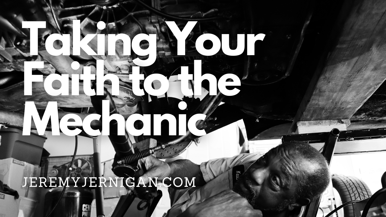 Black-and-white blog header image showing a mechanic working beneath a car, paired with the text “Taking Your Faith to the Mechanic.” The image symbolizes spiritual deconstruction, faith maintenance, and examining beliefs with care and guidance.