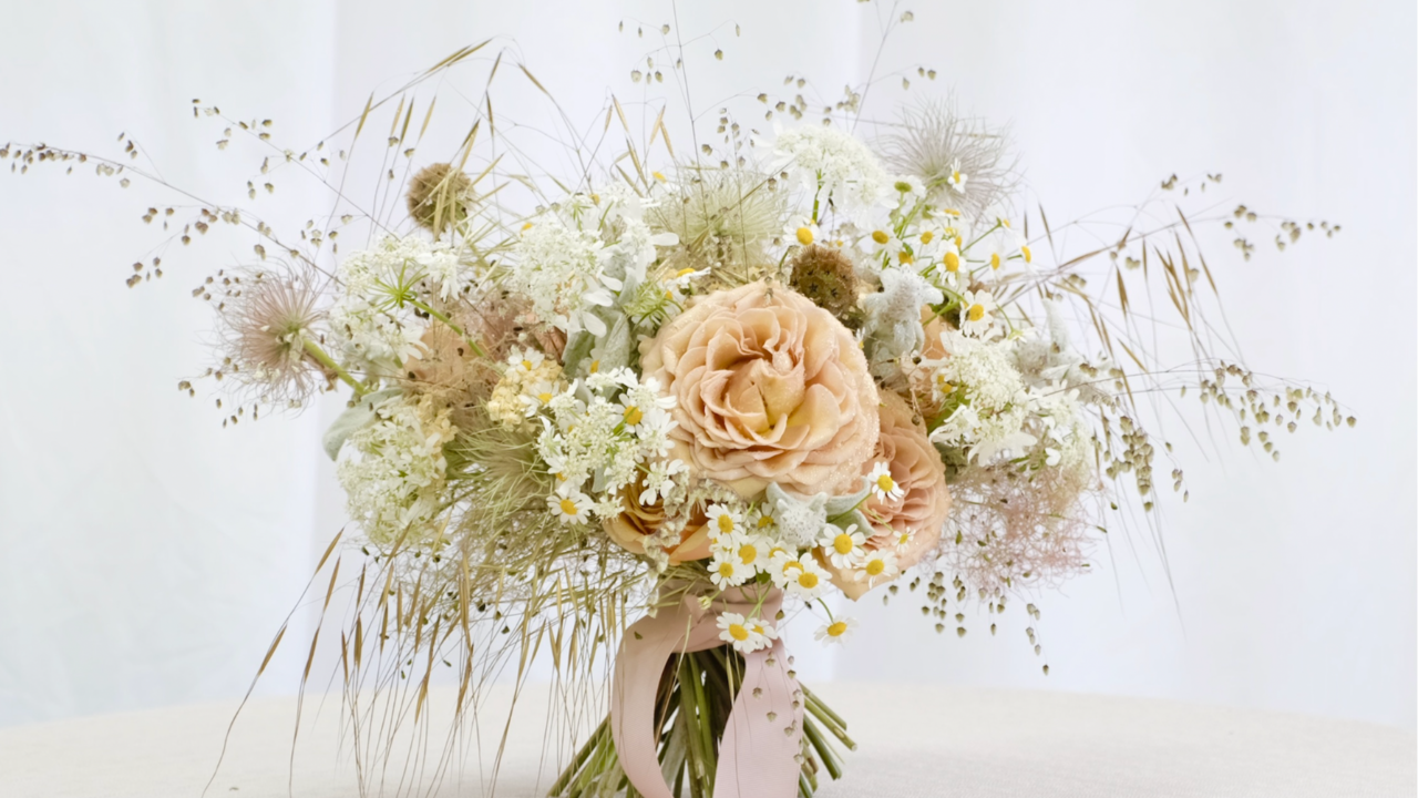 a bridal bouquet of peach roses with airy meadow detail bridal bouquet with soft peach tones and natural movement