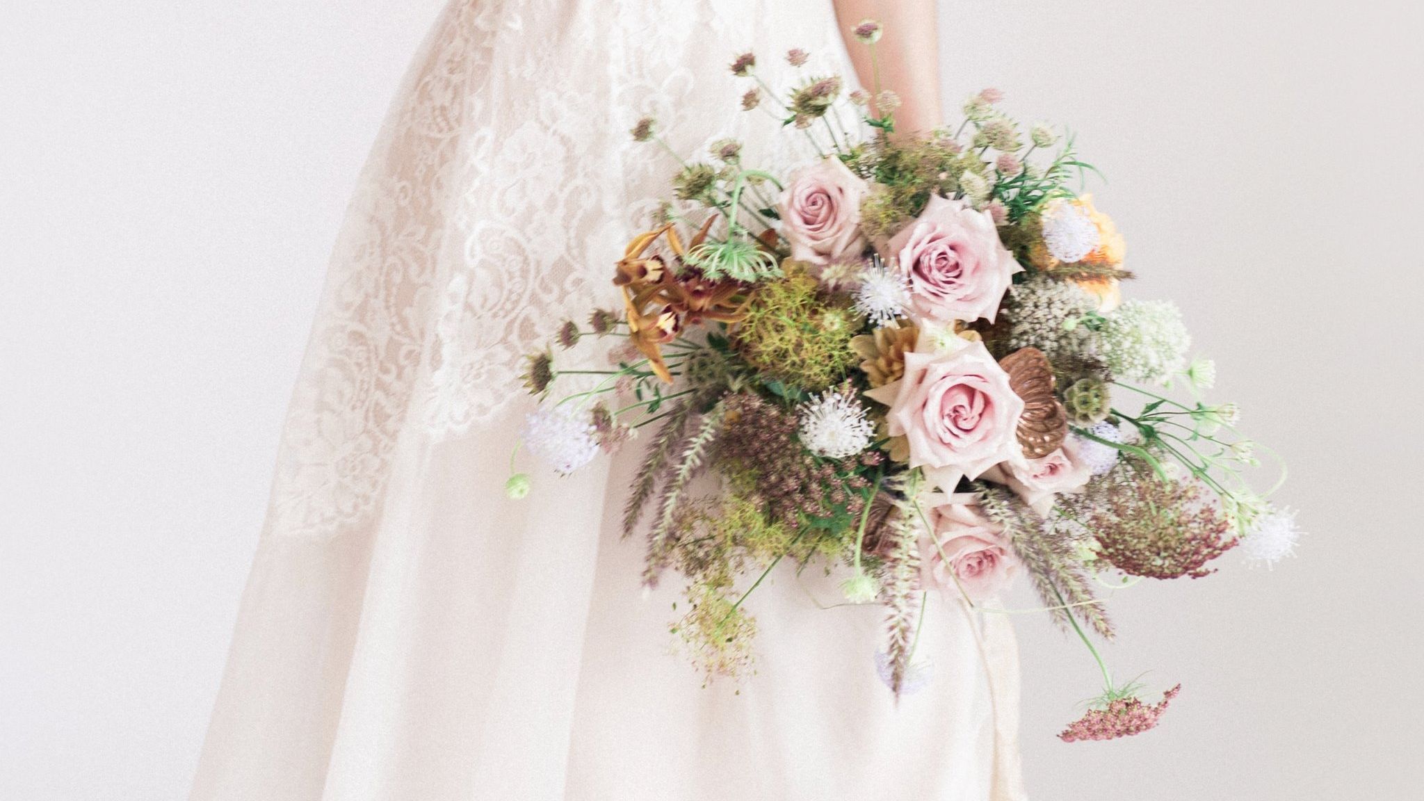 Bridal bouquet with soft pink roses, seasonal textures, and natural garden-style wedding floristry from Joseph Massie