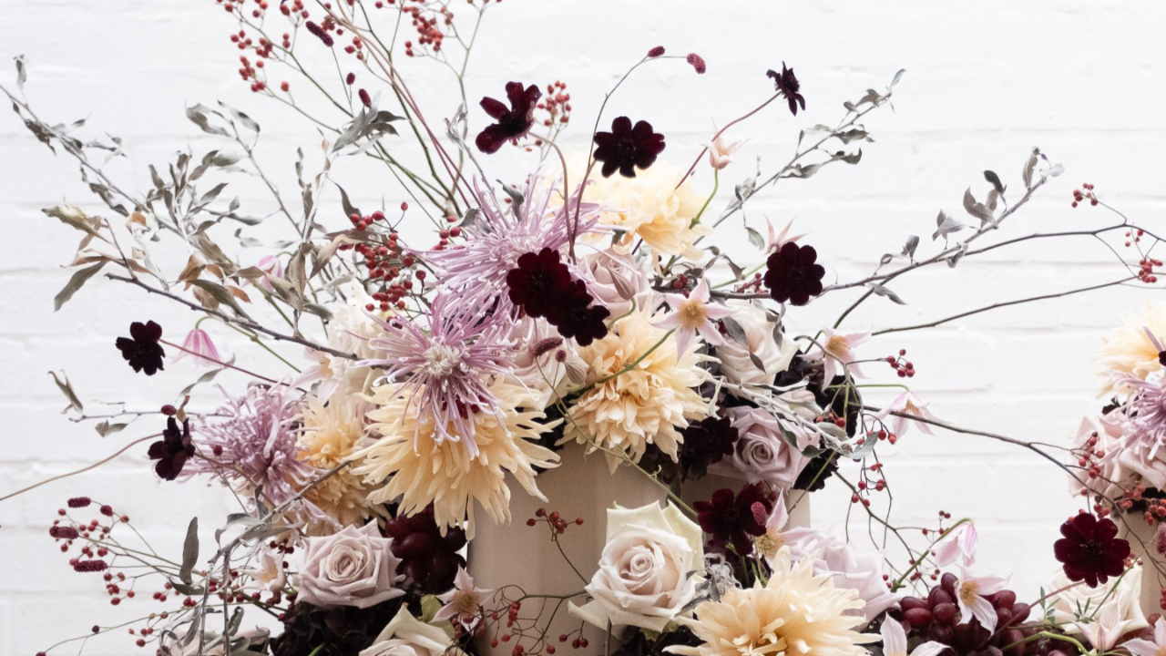 Luxury floral arrangement featuring blush garden roses, lisianthus, seed pods and trailing amaranthus in a naturalistic, contemporary style by floral designer Joseph Massie. Soft, romantic wedding flowers with textured botanicals and organic movement. Taken from the online course: Everyday, Elevated.