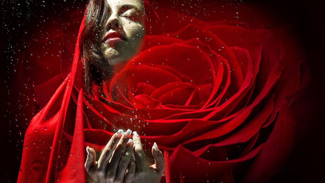 Woman dressed in red with a large red rose prominent in front conveying healing, peace, sophia-christos energy