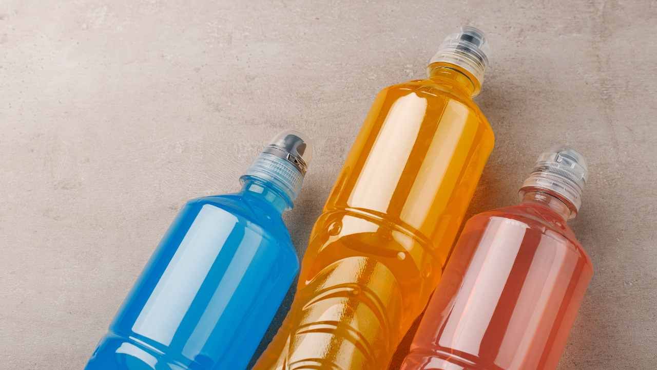 3 electrolytes drinks, one blue, one orange and one pink