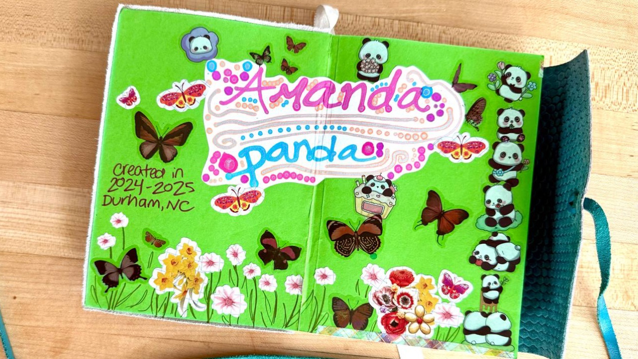 A journal with the text "Amanda Panda" and stickers