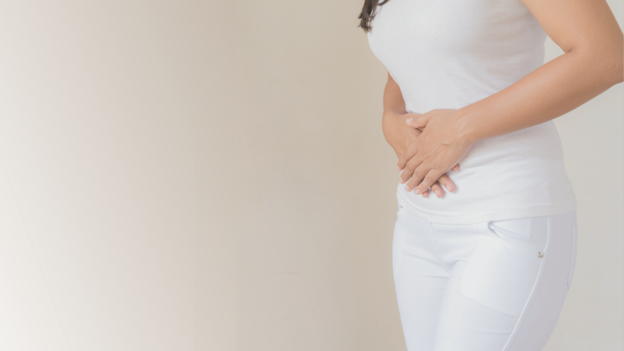 woman holding her bloated belly