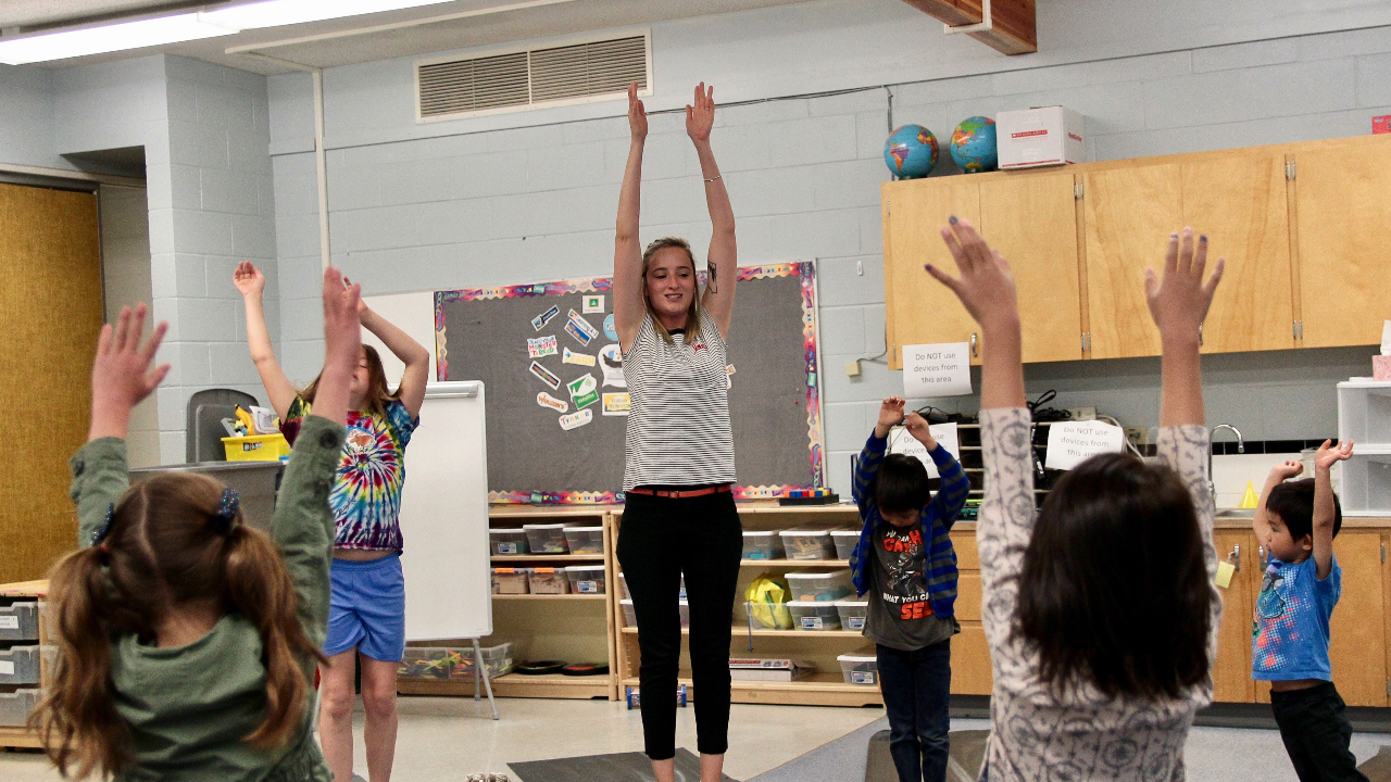 kids doing yoga wit instructor