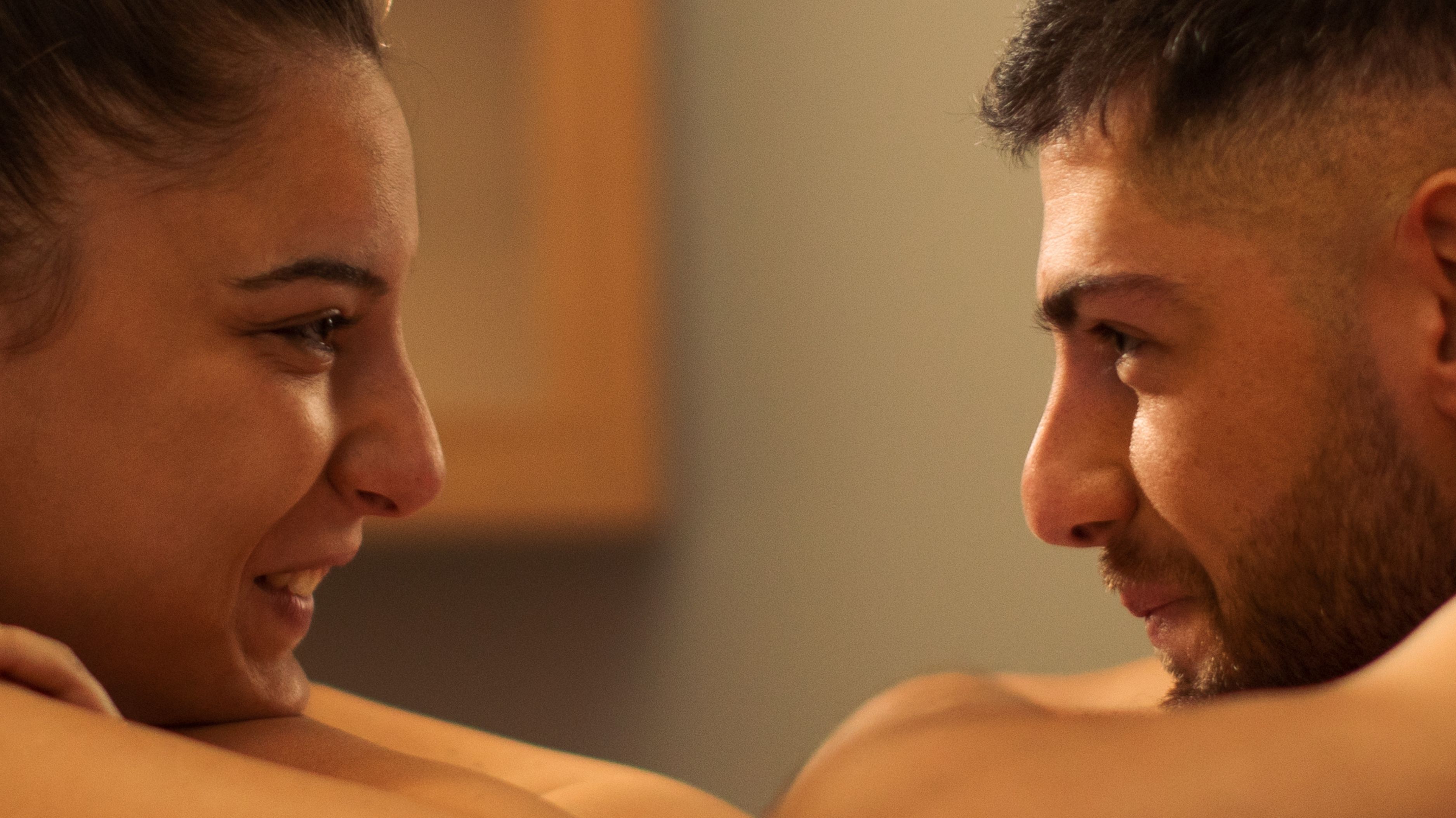 a couple looking into each other's eyes to show connection and pleasure