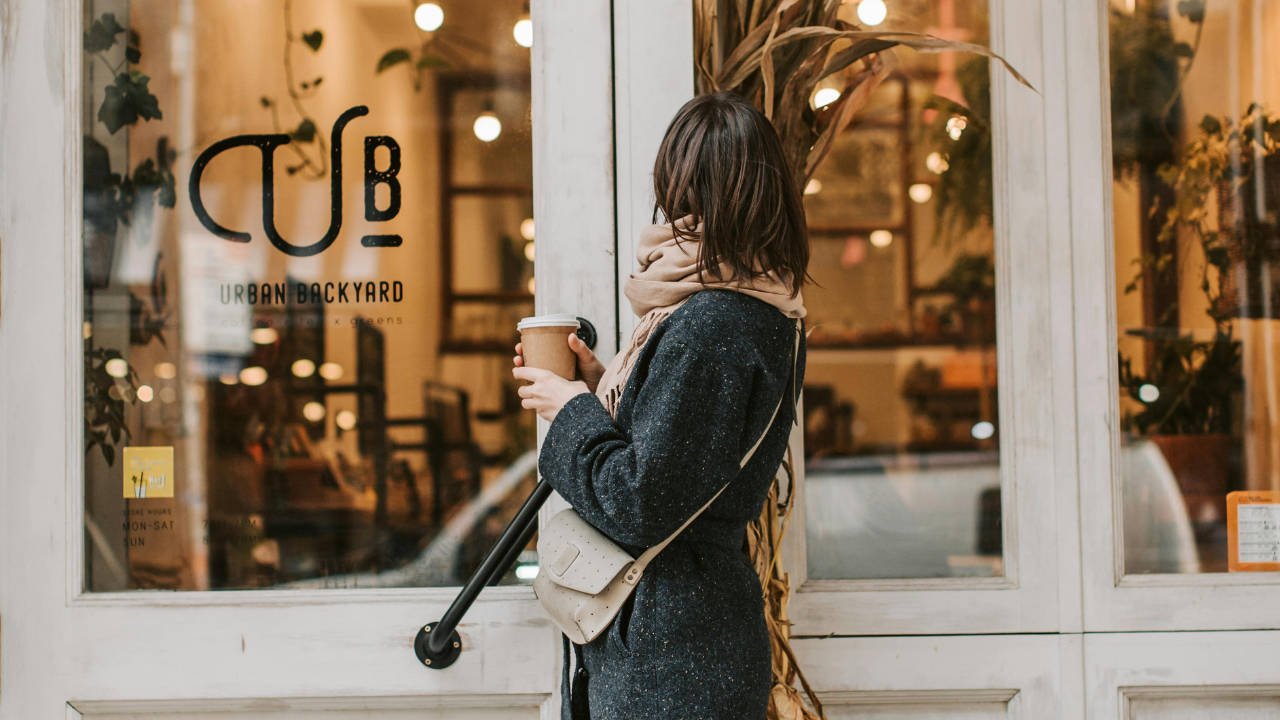 Woman taking notes, surrounded by books and taking notes