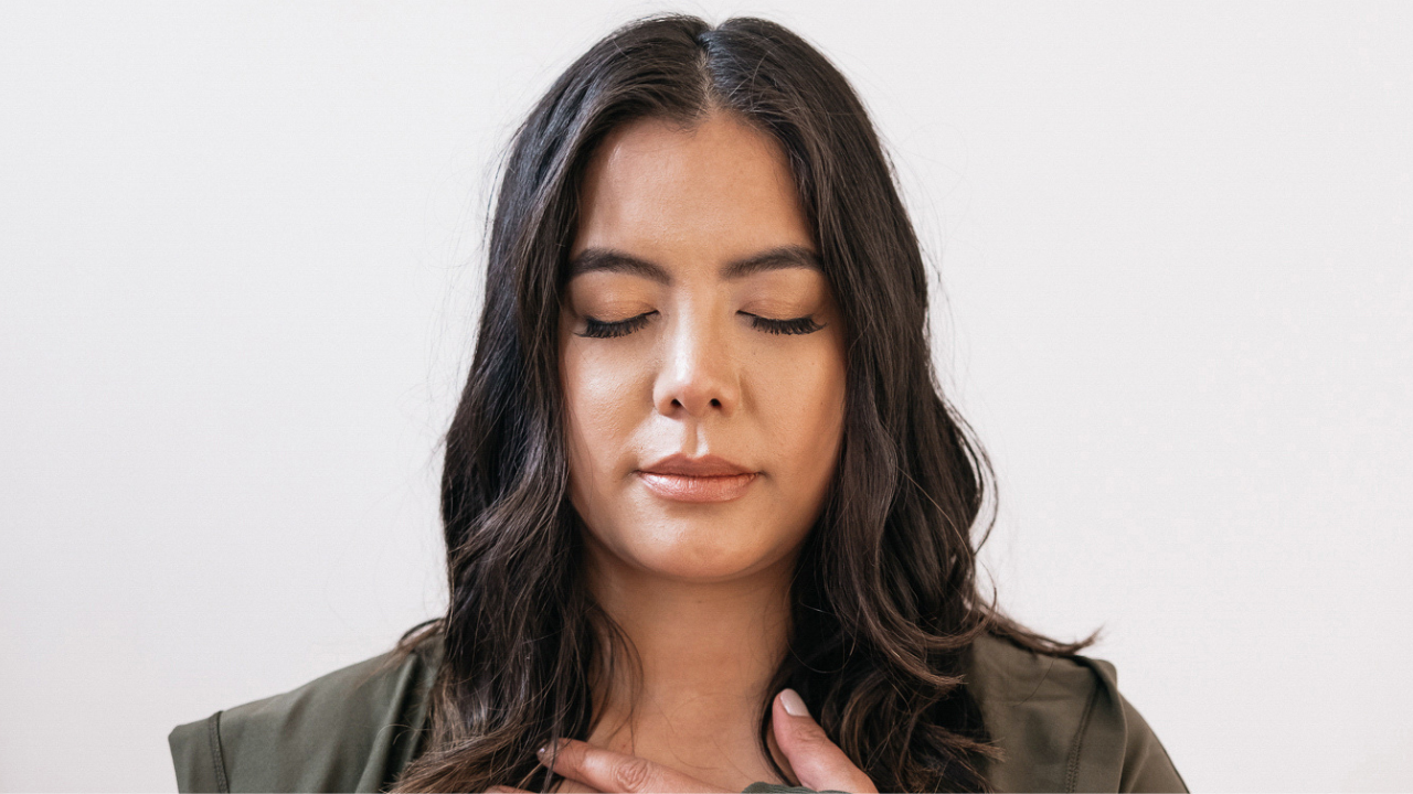 Woman with eyes closed trying to find her voice in English