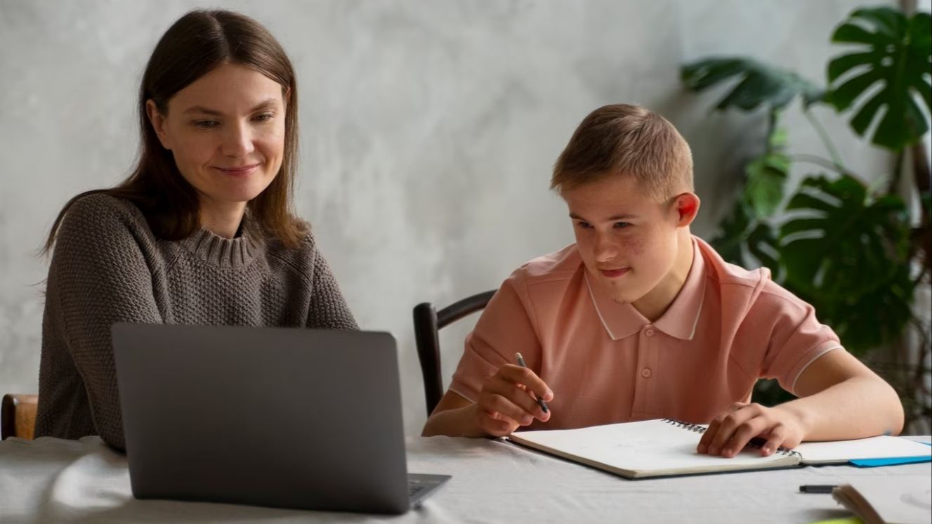 boy with down syndrome and laptop