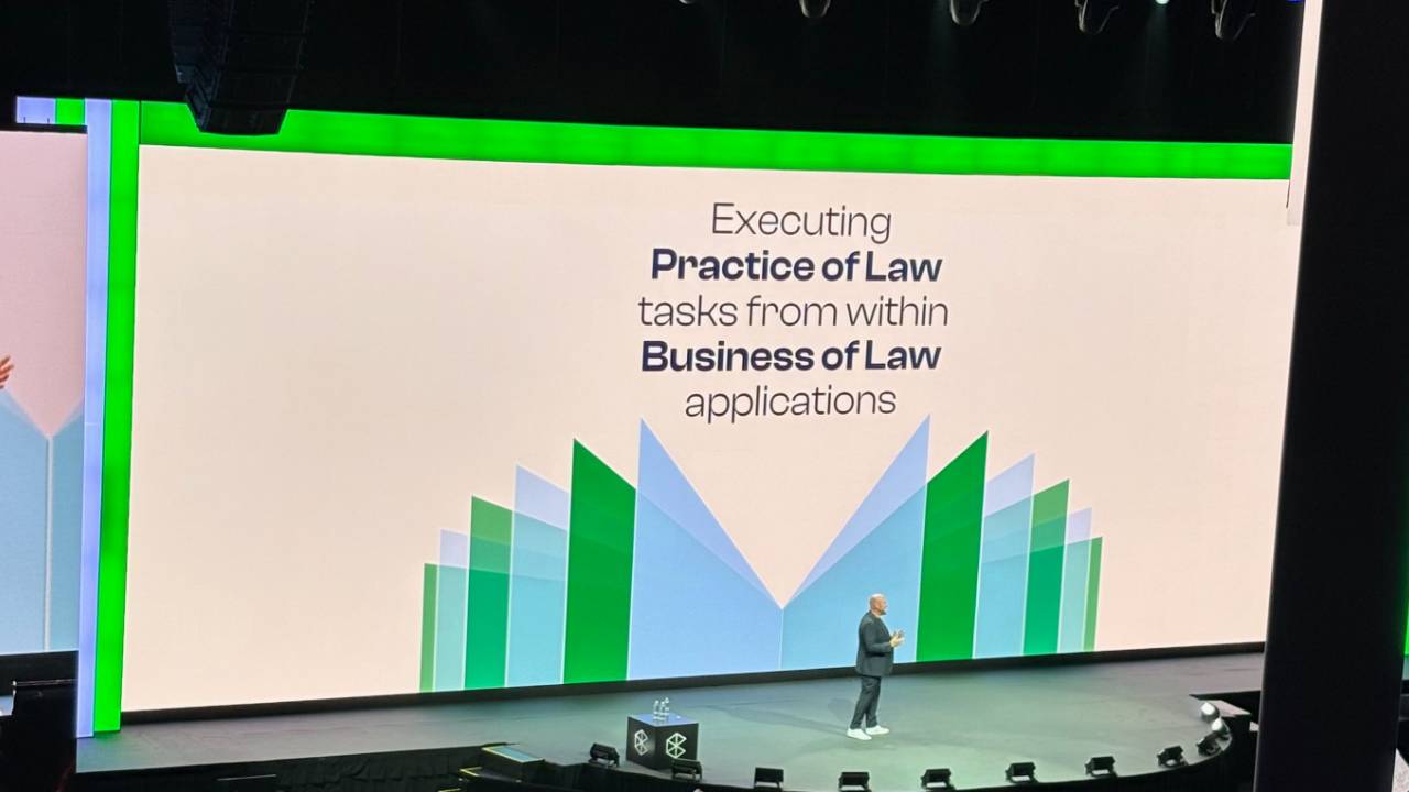 Jack Newton on stage at Clio, in front of a slide that reads