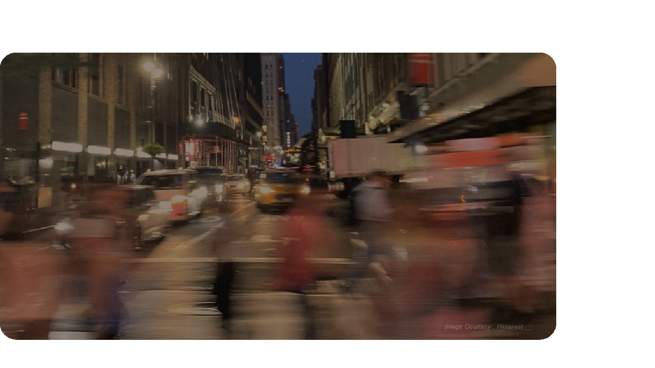 A busy road with people walking fast.