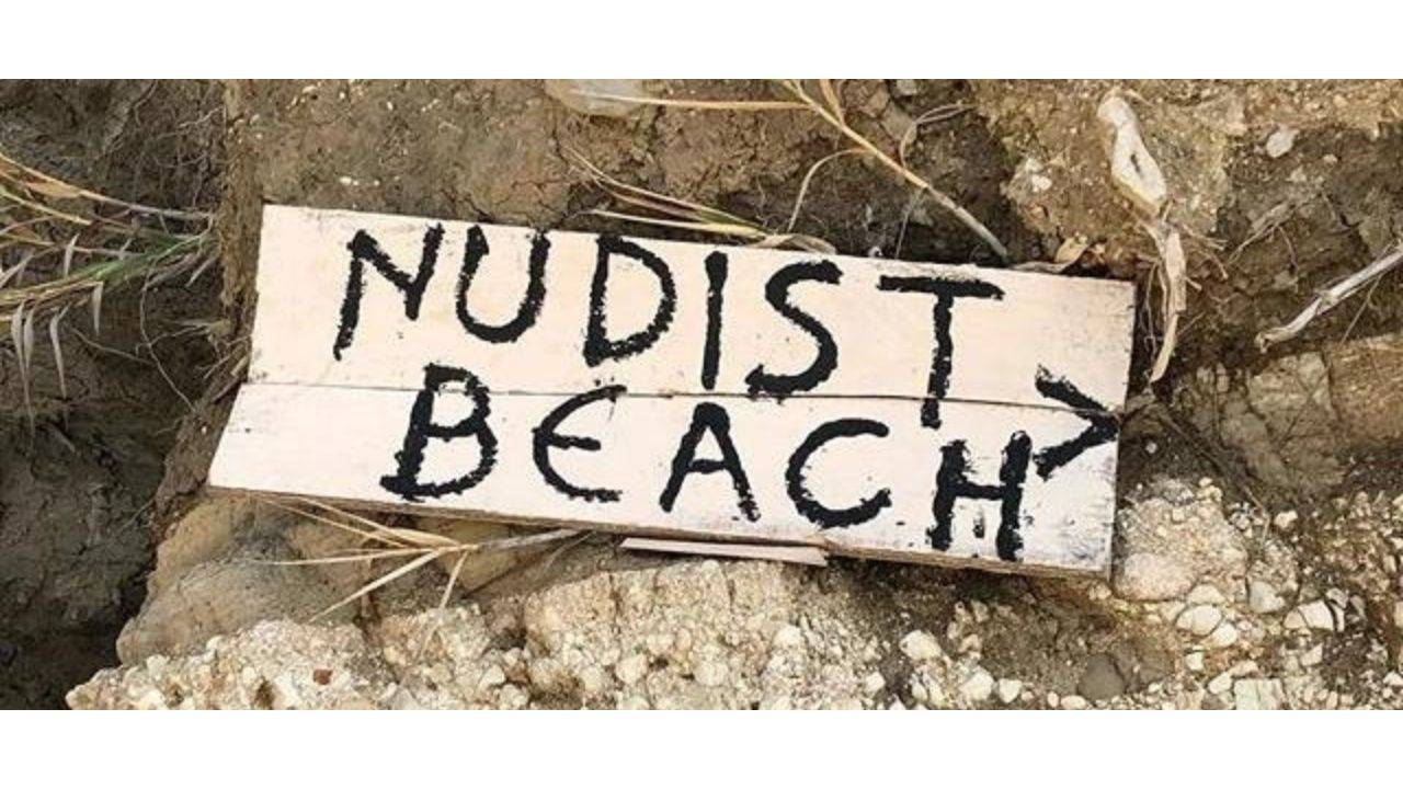 Sign saying "Nudist Beach"