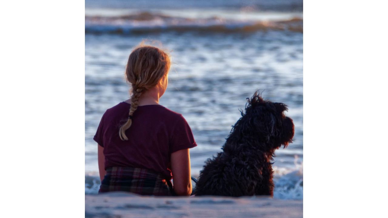 Woman dog seashore 