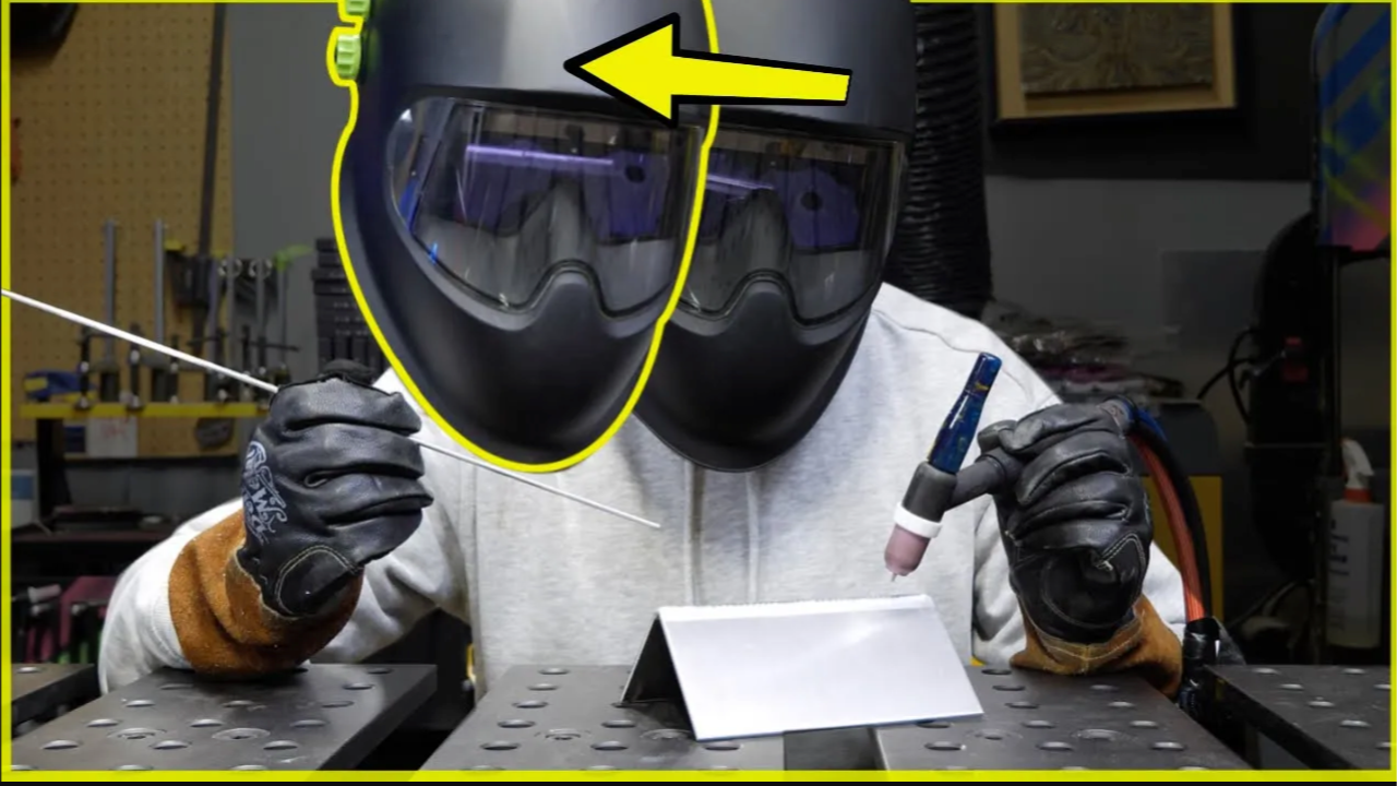 TIG welder demonstrating correct head position while holding a filler rod and TIG torch for improved weld visibility.