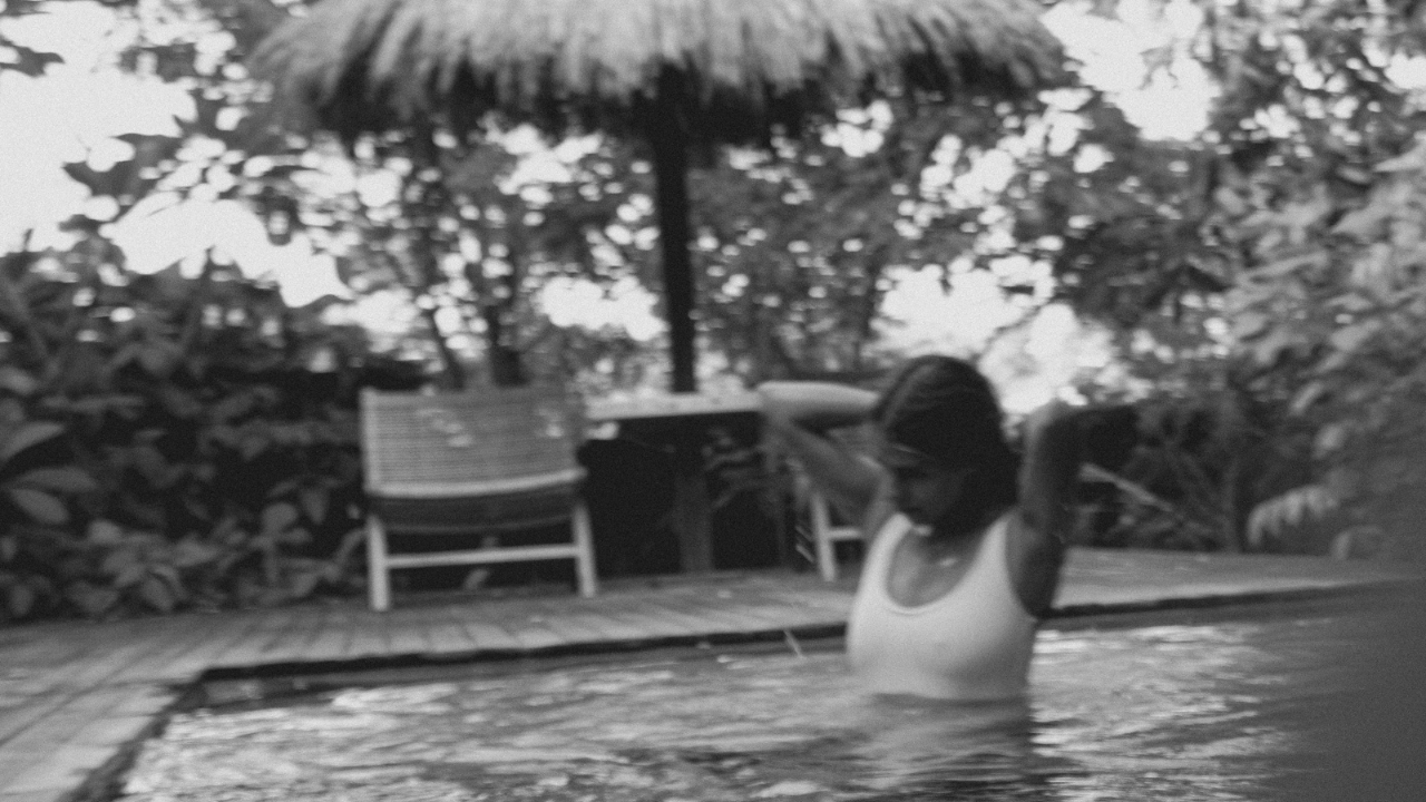 POV of a man watching a woman in the water, representing how strong feelings make him tense and unsteady around the women he cares about most.