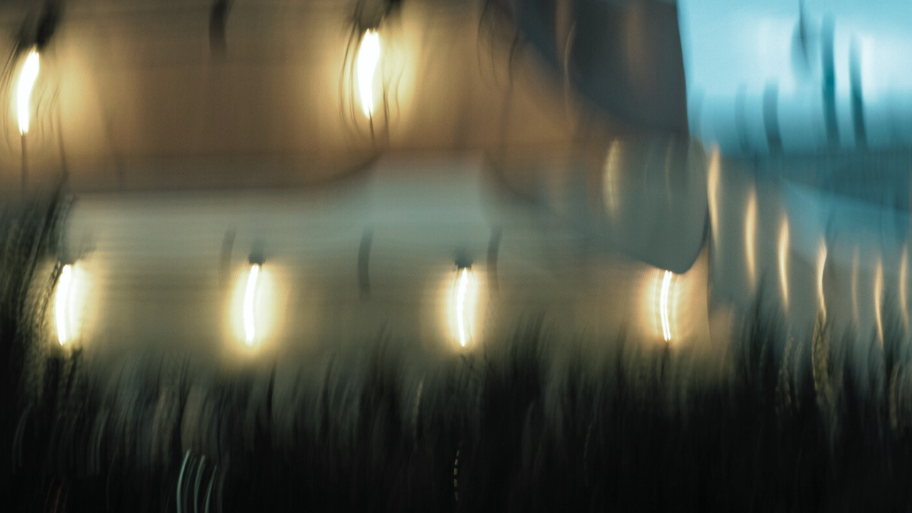 Blurred streaks of warm lights, symbolizing the internal confusion and emotional distortion caused by suppressed anger.